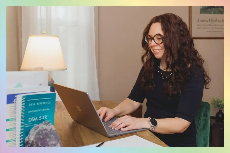 Alicia Kuzia, LMHC, NCC, ADHD-CCSP working at her home office in Amherst, MA to provide therapy services for teenagers and adults with ADHD and anxiety.